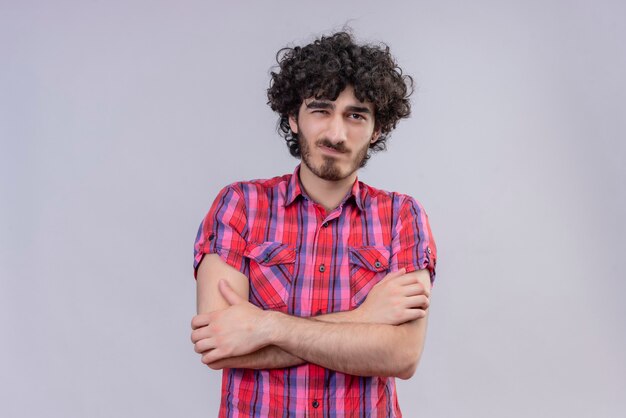 Young male curly hair isolated  colorful shirt crossed arms smirk