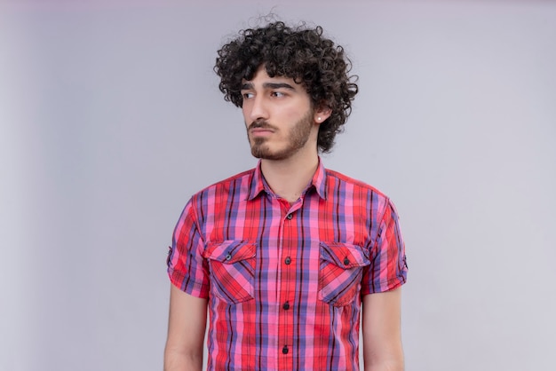 Young male curly hair isolated  colorful shirt looking away upset