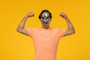 Young male flexing with scary golden mask yellow background cartoon