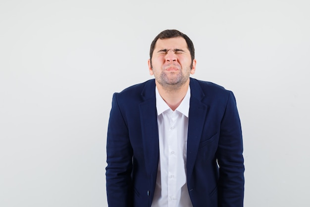 Young male frowning his face in shirt