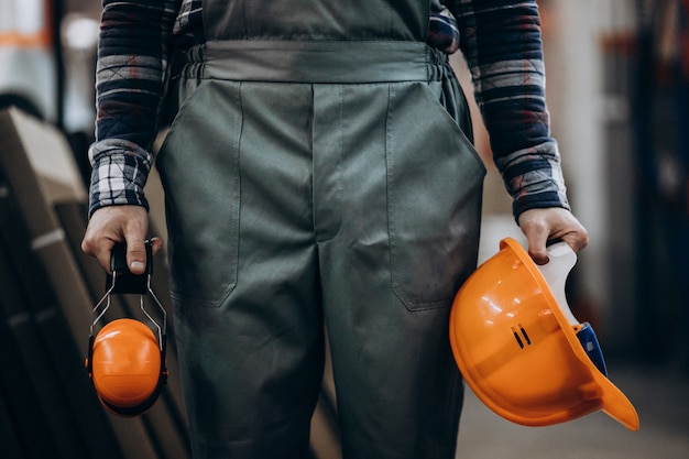 Young male handyman with safety earphones