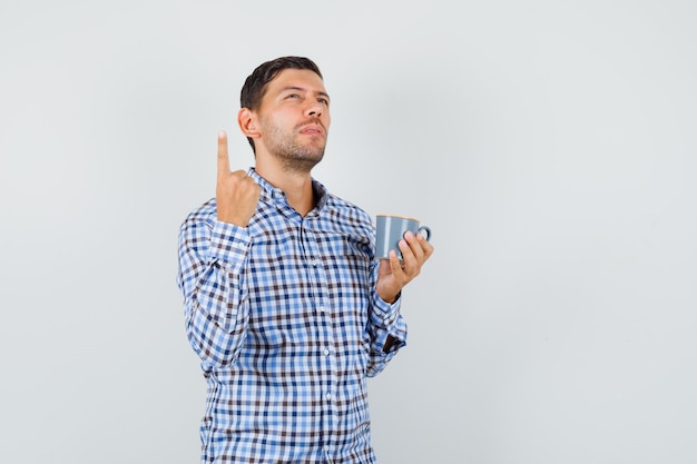 Young male holding cup of drink