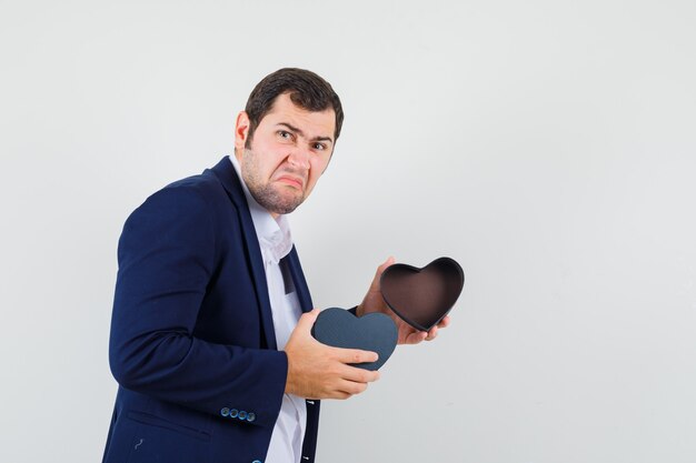 Young male holding empty gift box in shirt