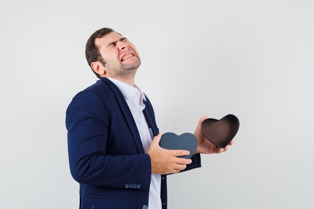 Young male holding empty gift box in shirt