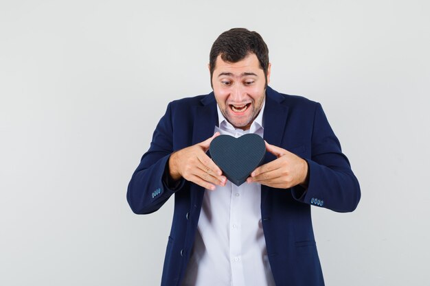 Young male holding gift box in shirt