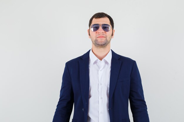 Young male looking through glasses in shirt