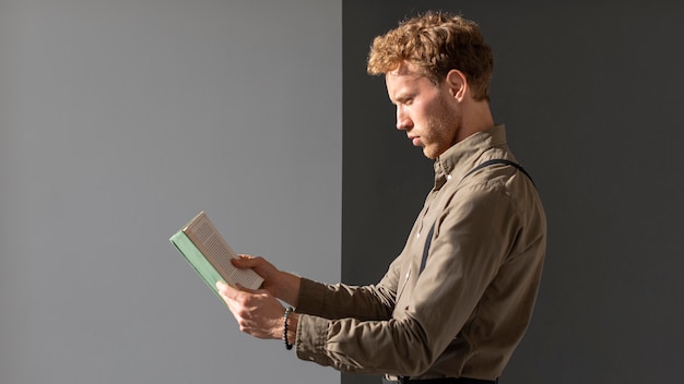 Young male model reading side view