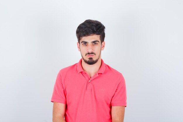 Young male in pink t-shirt and looking sensible. front view.