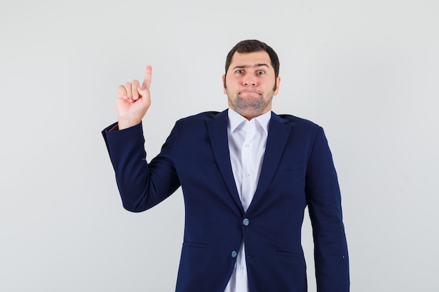 Free photo young male pointing up in shirt