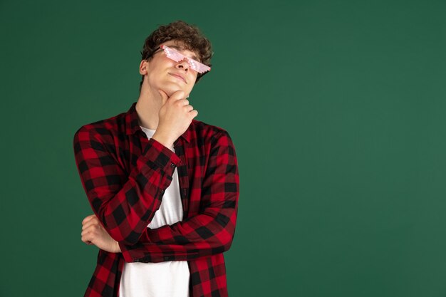 Young male portrait isolated over  wall with copyspace