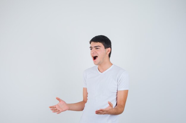 Free Photo  Handsome young male pretending to show something in