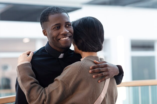 Young male priest meeting a woman for spiritual direction