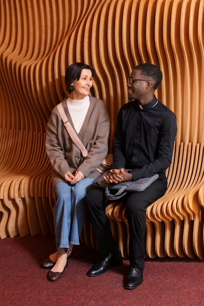 Young male priest with a female worshiper meeting for direction