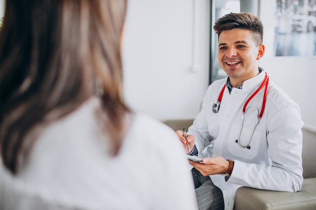 Young male psysician with patient at hospital