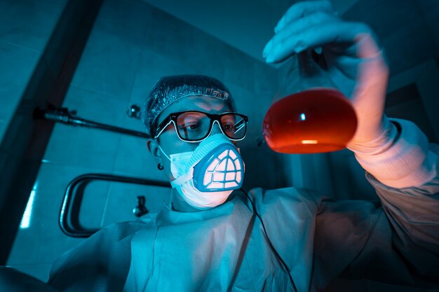 Young male researcher carrying out scientific experiment.