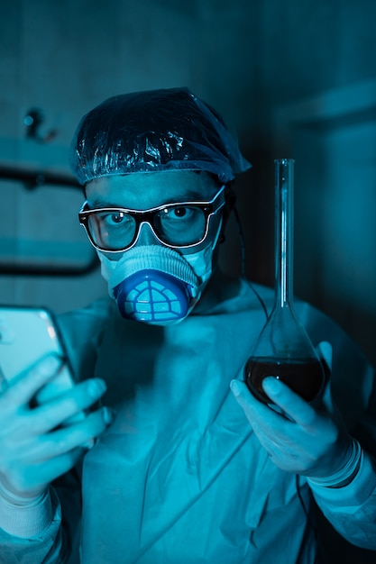 Young male researcher carrying out scientific experiment