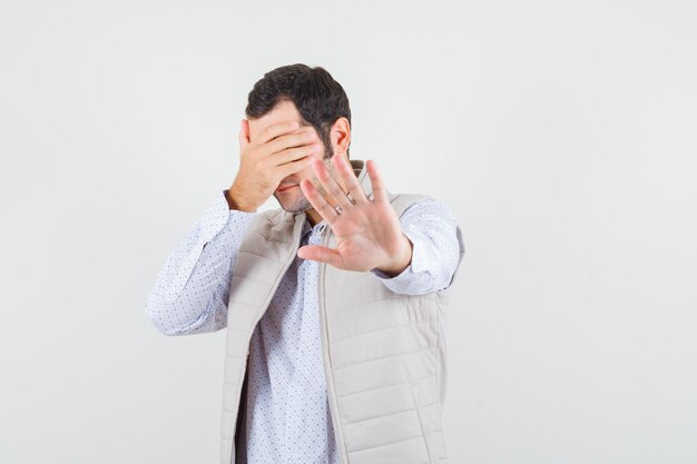 Young male showing stop gesture in shirt