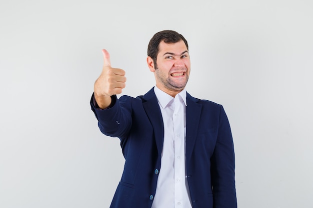 Young male showing thumb up in shirt