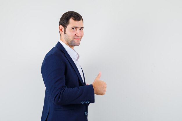 Young male showing thumb up in shirt