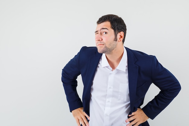 Young male standing to hear clearly in shirt