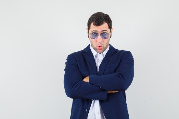 Young male standing with crossed arms in shirt