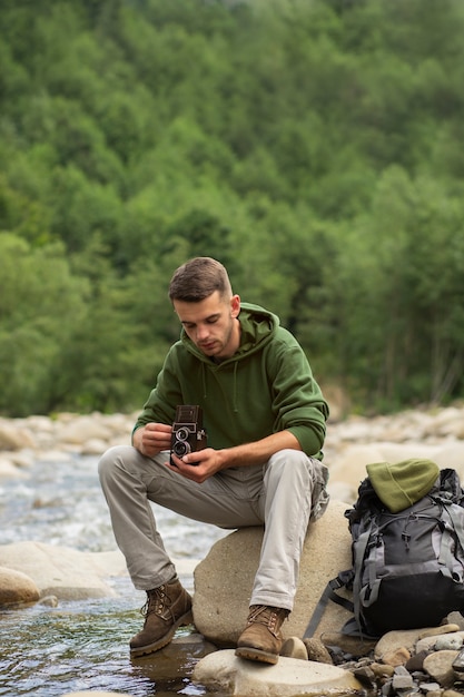 Young male traveler enjoying rural surroundings