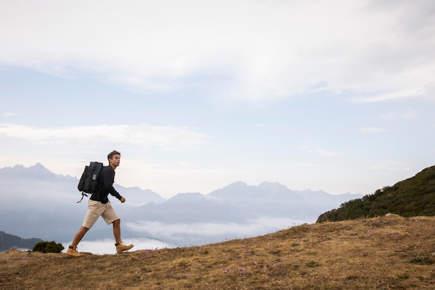 Young male traveler hiking alone with copy space