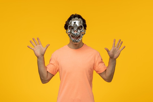 Young male with scary golden mask yellow background cartoon