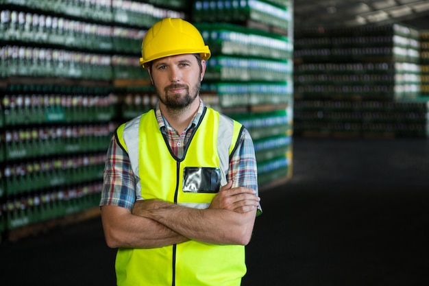 Young male worker standing in warehouse