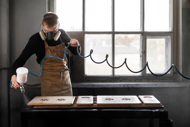 Free photo young male working in a wood engraving workshop