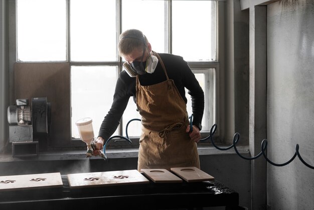 Young male working in a wood engraving workshop