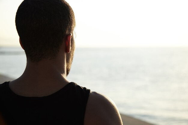 Young man admiring landscape at beach