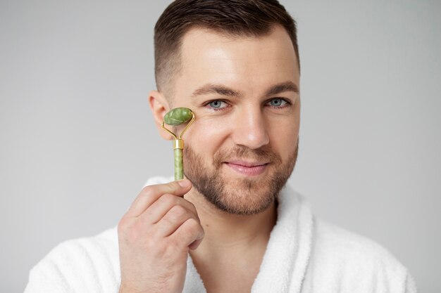 Young man applying his anti aging treatment