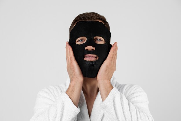 young man applying his anti aging treatment