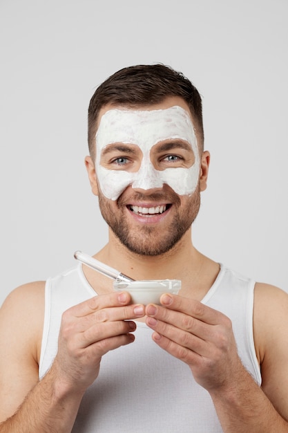 Young man applying his anti aging treatment