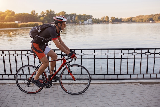 Young man are cycling road bike in the evening