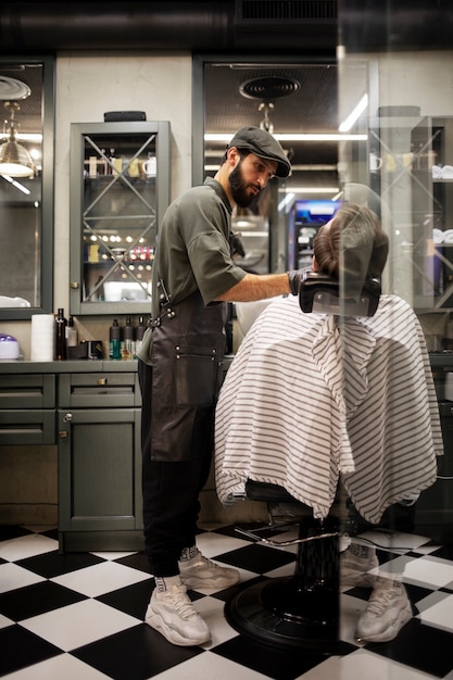 Young man at the barber's shop getting his beard trimmed