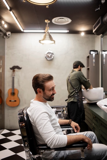 Young man at the barber shop after getting a haircut