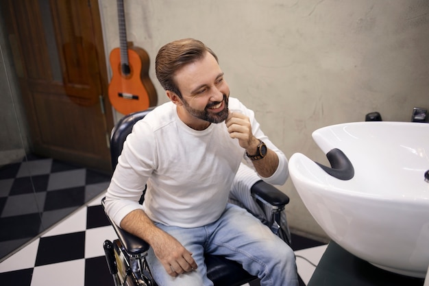 Young man at the barber shop after getting a haircut