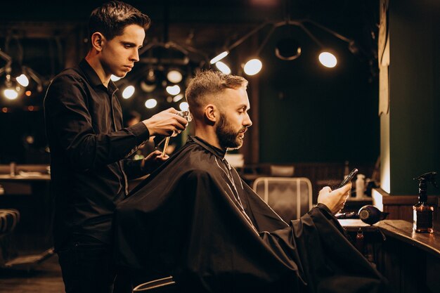 Young man at barbershop trimming hair