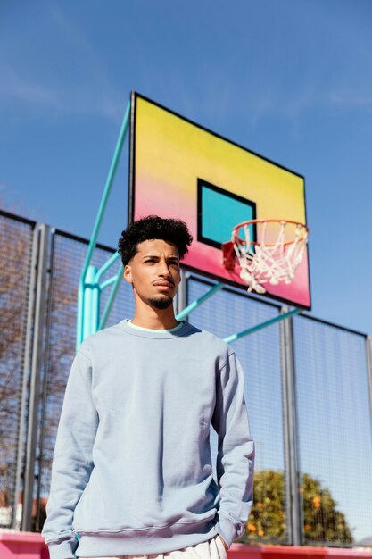 Young man on basket field