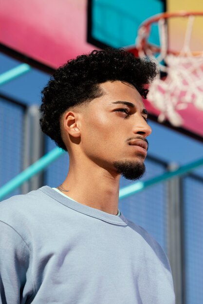 Young man on basket field