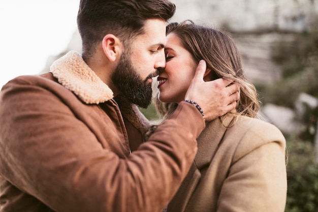 Young man and beautiful woman preparing to kiss