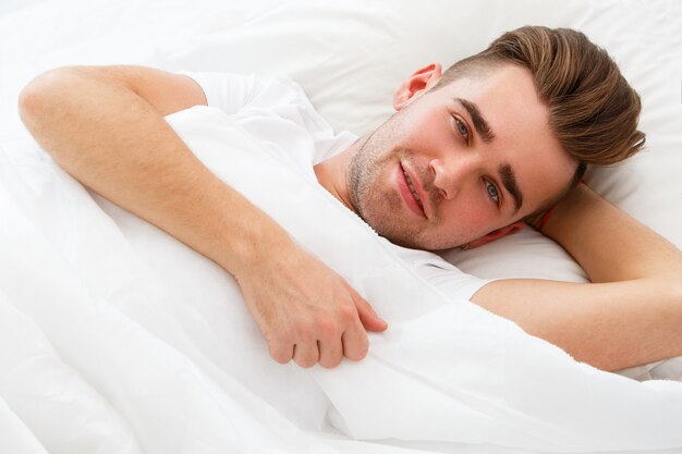 Young man in the bed