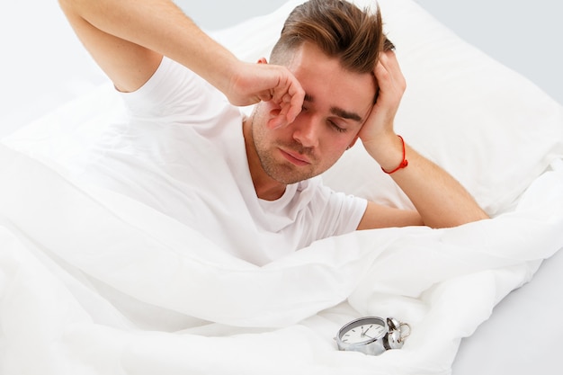 Young man in the bed