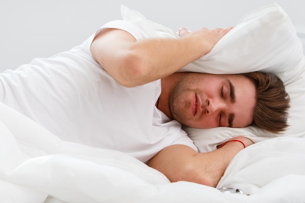 Young man in the bed