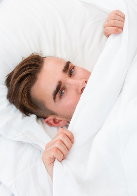 Young man in the bed