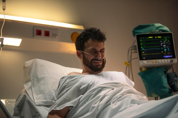 Free photo young man being ill in a hospital bed