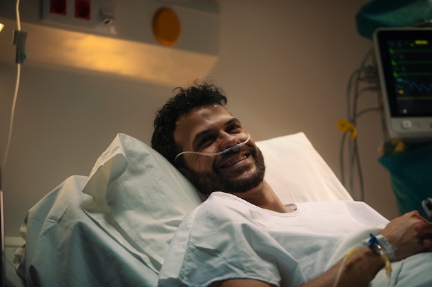 Free photo young man being ill in a hospital bed