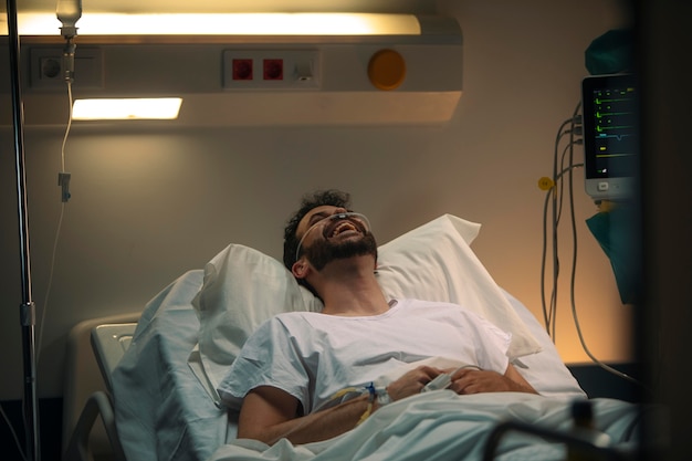 Free photo young man being ill in a hospital bed